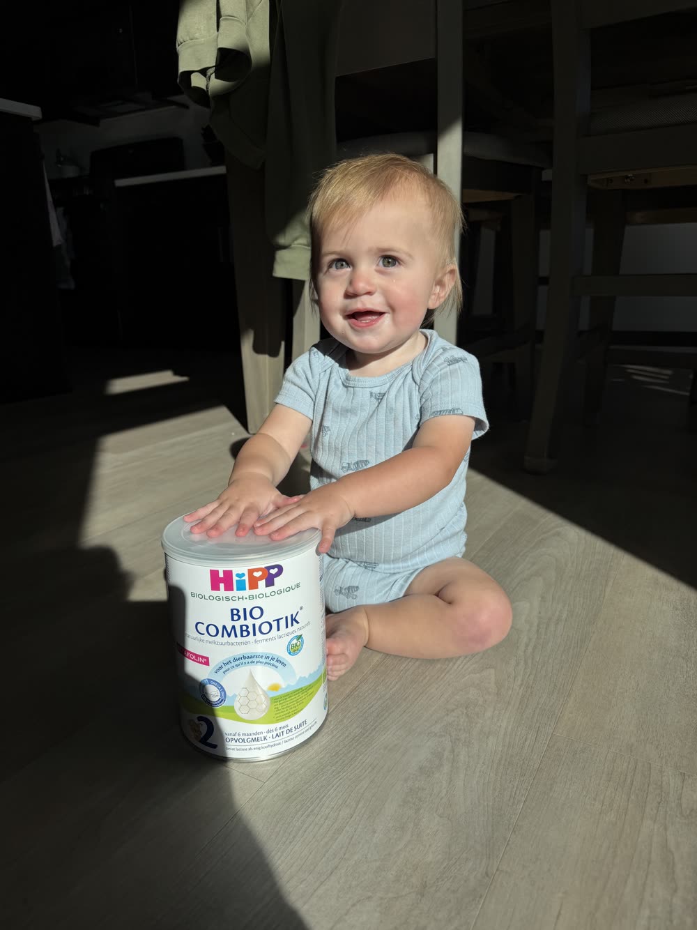 Tatum's baby holding a can of HiPP Dutch